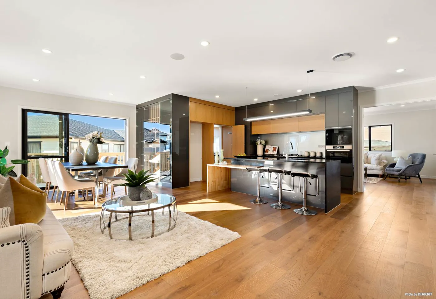 Timber and charcoal kitchen opening into a light living space