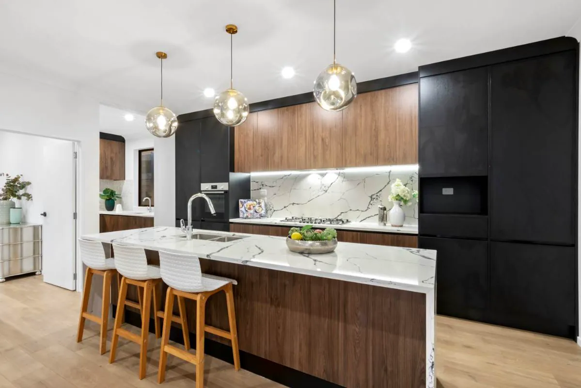 Black kitchen with timber finish and marble-look splashback