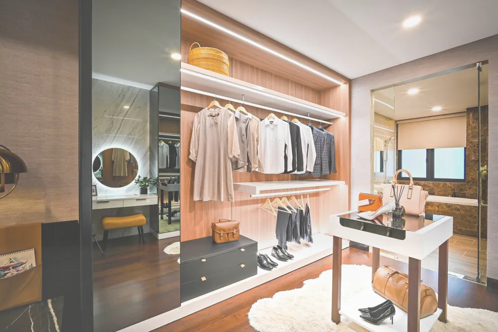 Walk-in wardrobe with warm timber shelving and integrated lighting